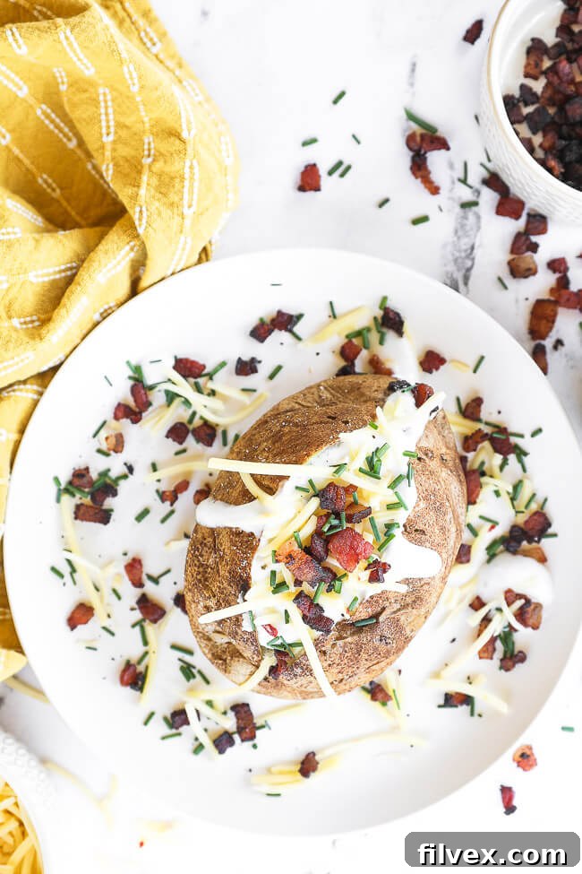 Air fryer basket with baked potatoes