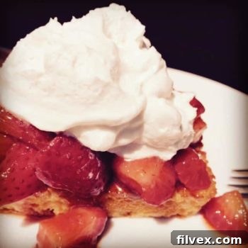Beautifully plated Strawberry Lemon Shortcake topped with fresh berries and whipped cream.