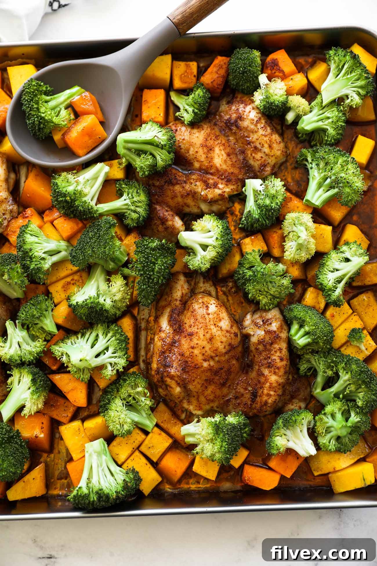 A close-up of the perfectly cooked one-pan chicken and broccoli, highlighting the crispy chicken skin and tender vegetables.