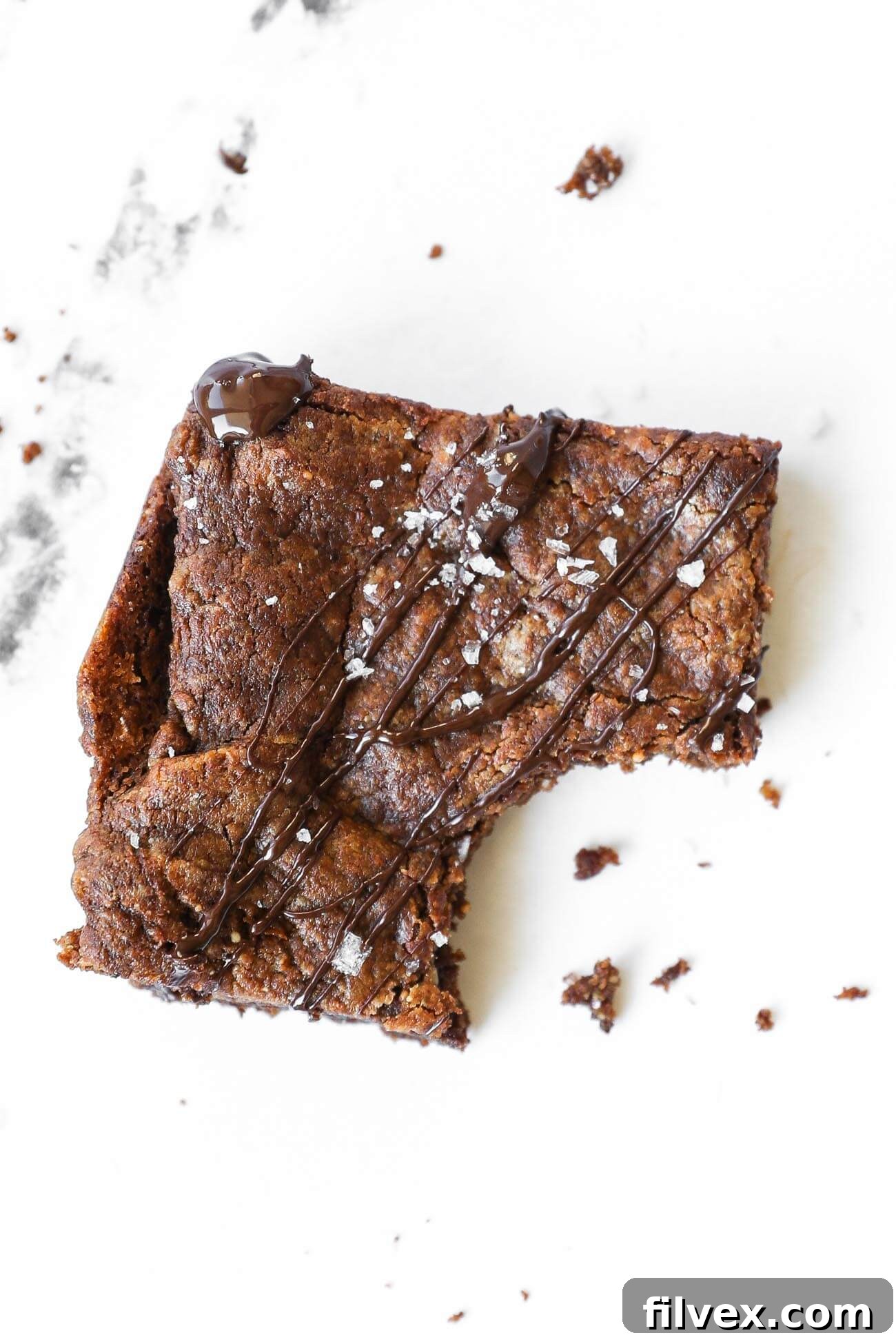 Vertical image of a stack of three dairy-free brownies, showcasing their fudgy interior.