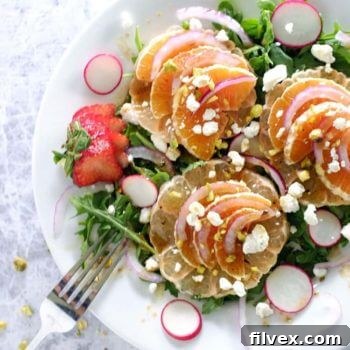 Summer citrus salad with arugula, oranges and sliced radishes