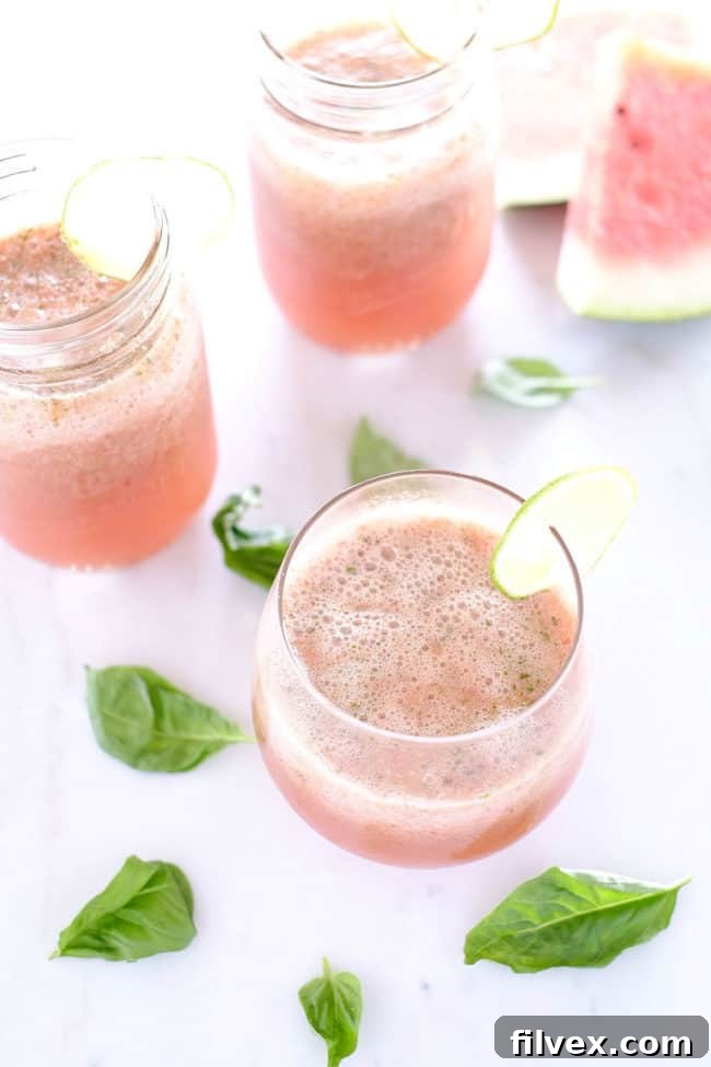 Close-up of Strawberry Basil Watermelon Agua Fresca with lime garnish