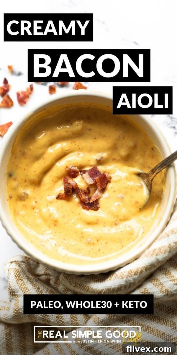 Homemade bacon aioli in a jar with a wooden spoon and bacon bits