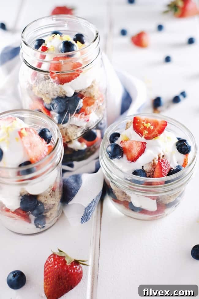 Individual Paleo Berry Lemon Shortcake jars with fresh fruit and whipped coconut cream. A healthy and festive summer dessert idea.
