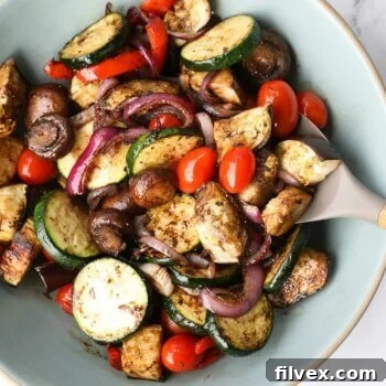 Grilled vegetable marinade tossed with grilled veggies in a bowl.