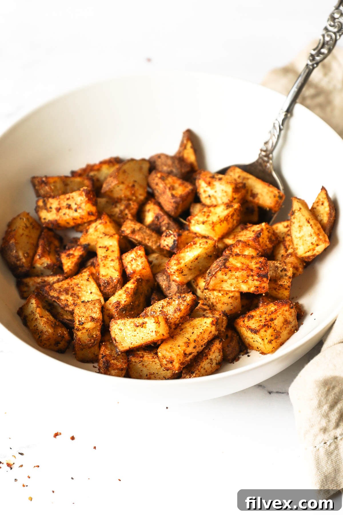 Air Fryer Basket Filled with Crispy Breakfast Potatoes
