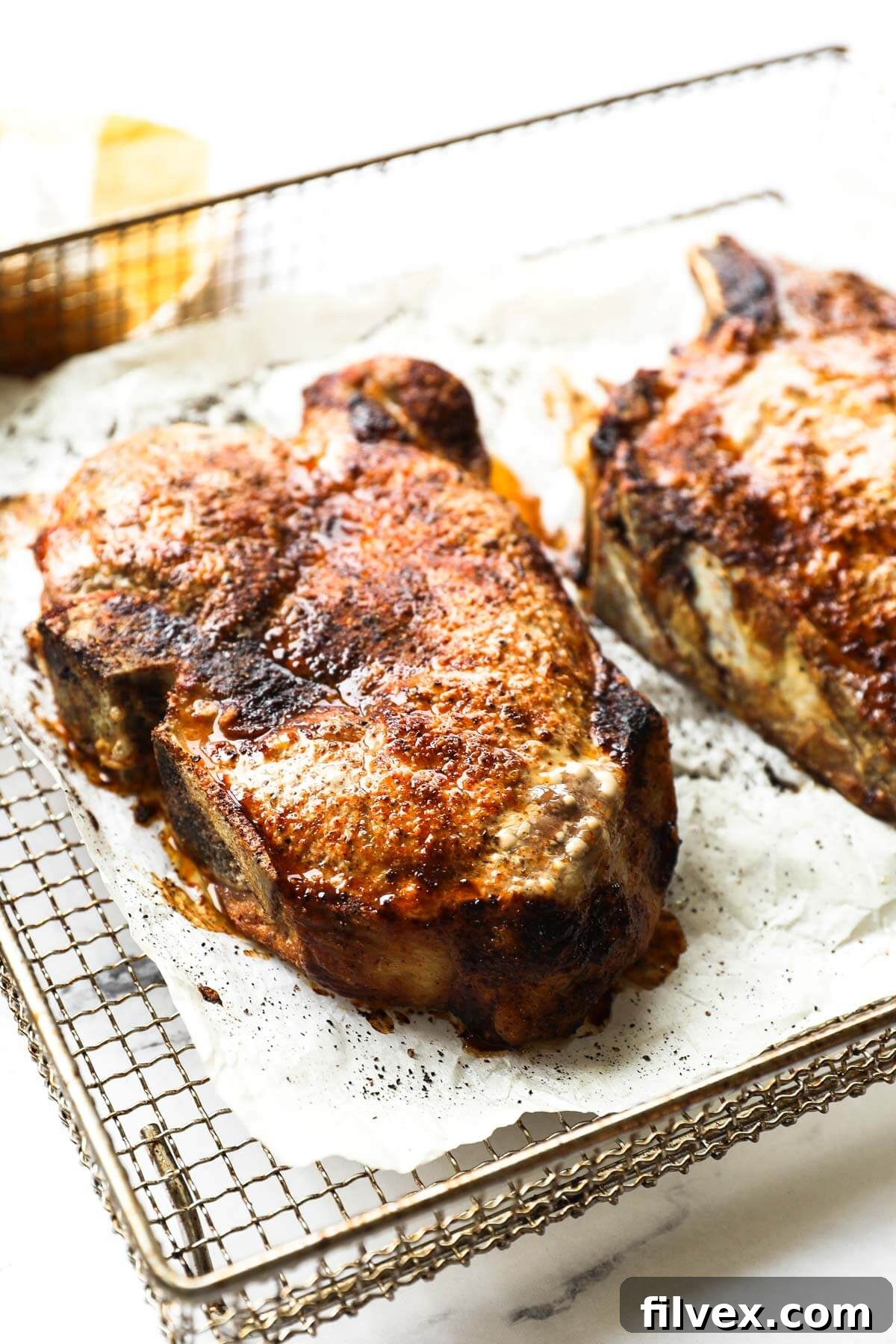 A colorful array of ingredients for homemade pork chop seasoning, including various spices in small bowls.