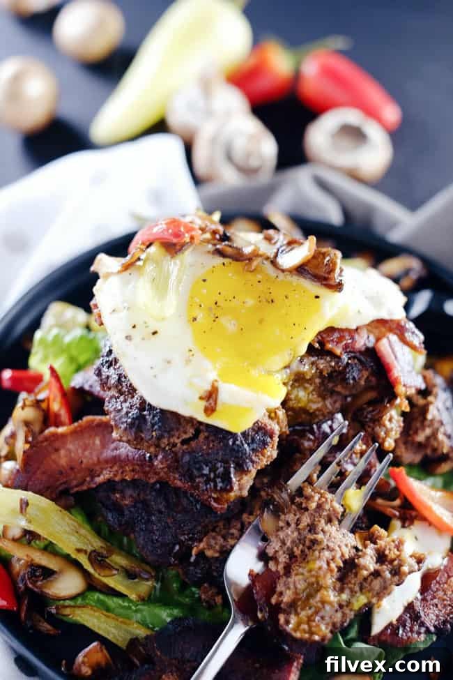 These chipotle bison burgers are an easy Paleo + Whole30 alternative to regular hamburgers. Topped with bacon, egg, peppers and mushrooms for amazing flavor! Paleo, Whole30, Gluten-Free + Dairy-Free | realsimplegood.com
