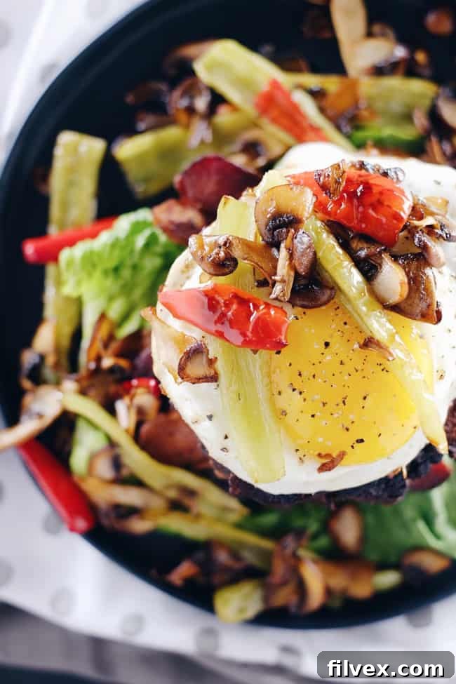 These chipotle bison burgers are an easy Paleo + Whole30 alternative to regular hamburgers. Topped with bacon, egg, peppers and mushrooms for amazing flavor! Paleo, Whole30, Gluten-Free + Dairy-Free | realsimplegood.com