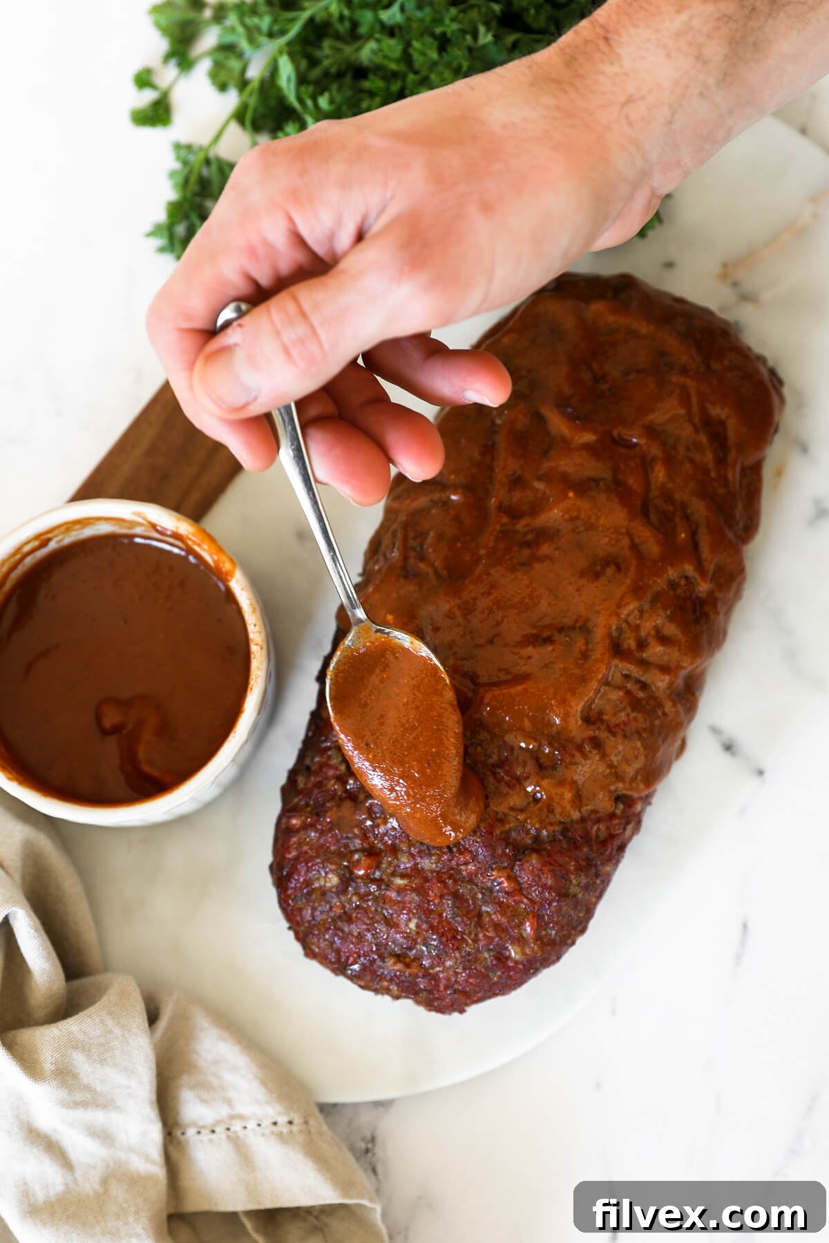 Smoked meatloaf on a smoker with a glaze brushed on top.