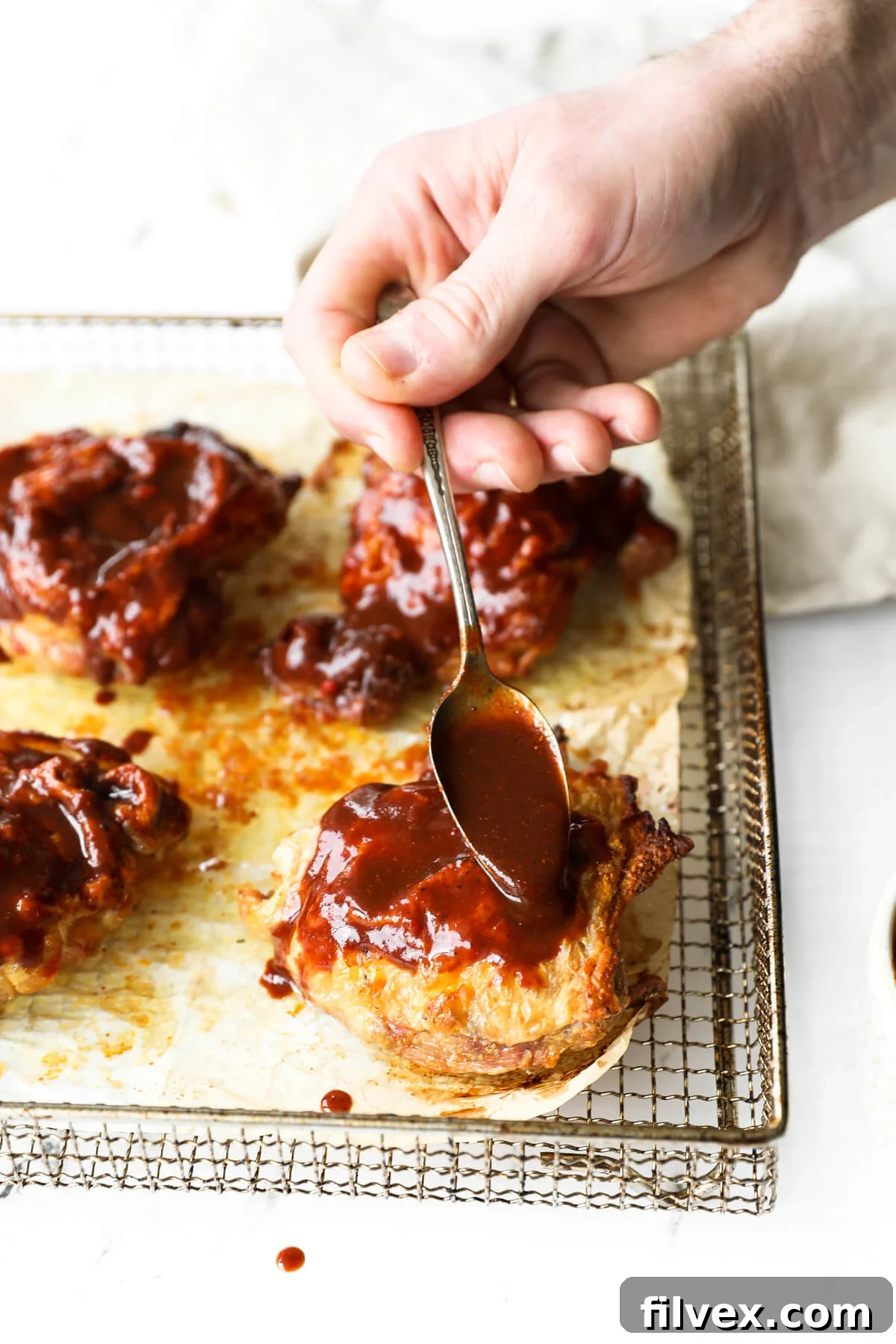 Air Fryer BBQ Chicken Thighs, cooked to perfection with crispy skin and a luscious sauce.