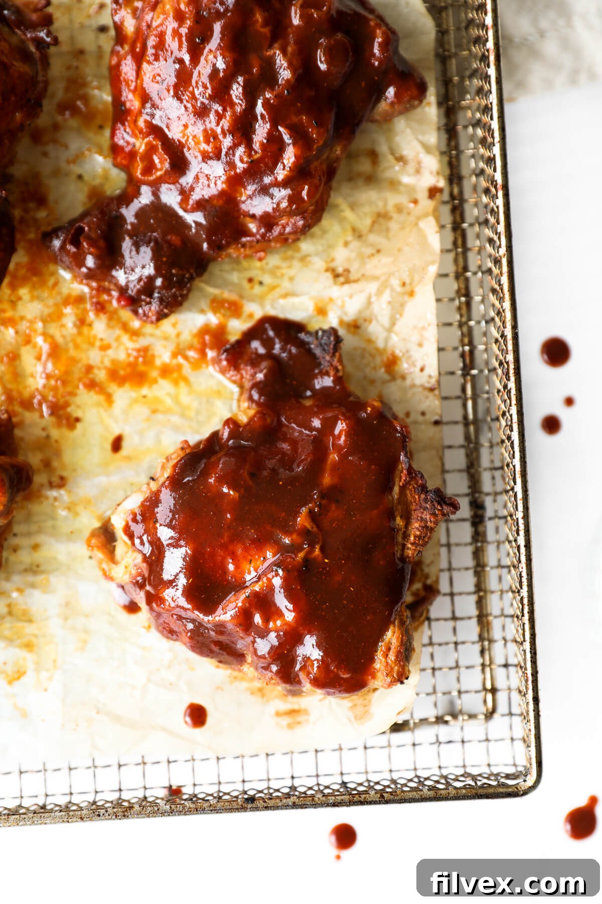 Close-up of a single Air Fryer BBQ Chicken Thigh, showing crispy skin and succulent meat.