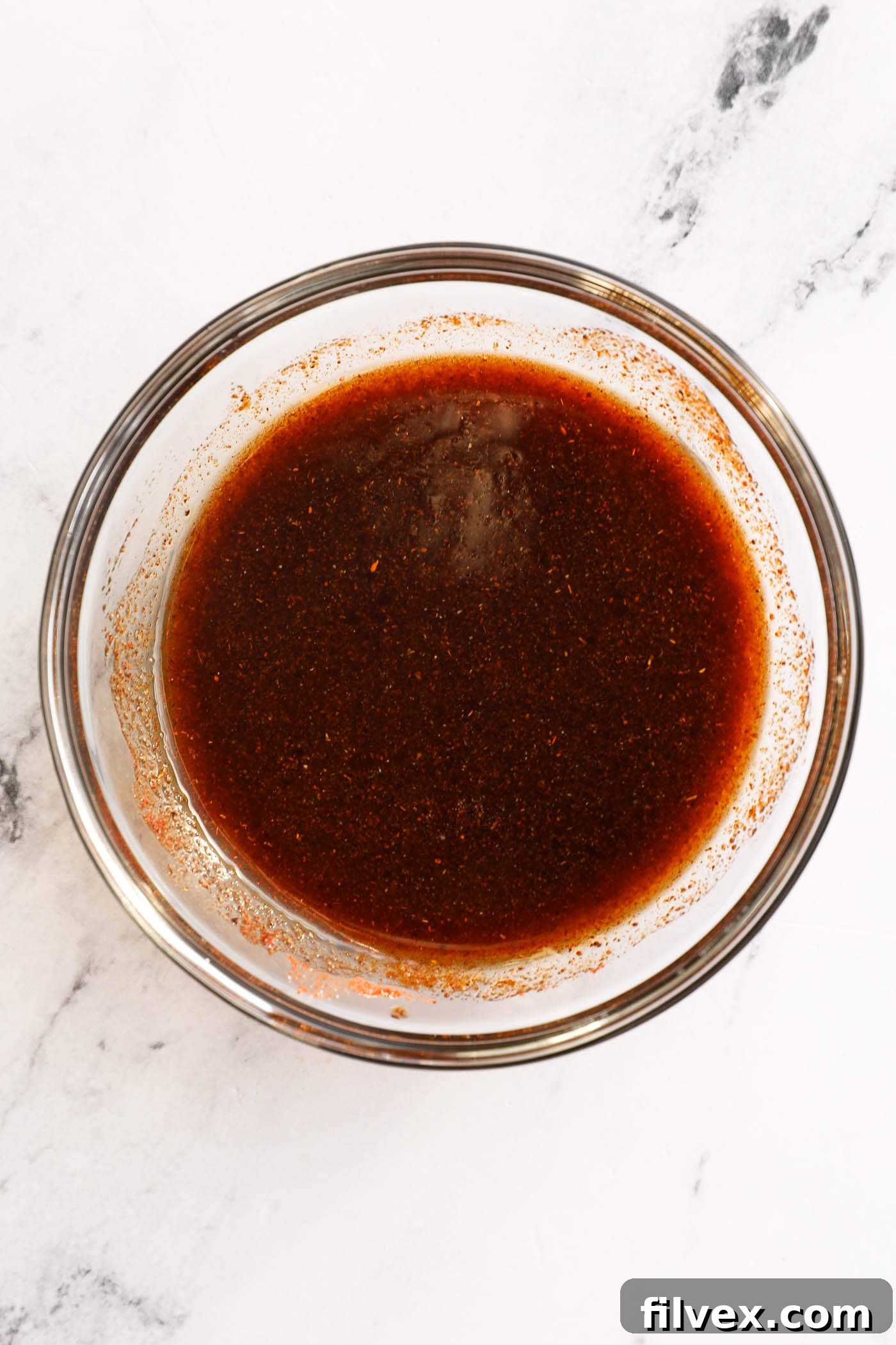 Whisking sauce ingredients in a small bowl