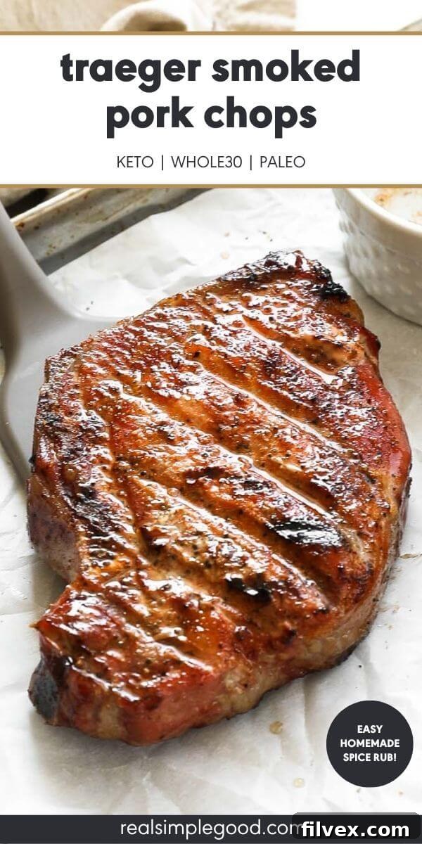 Close-up, angled view of a perfectly smoked Traeger pork chop, highlighting its tender interior and crispy, seasoned exterior, with the text "Traeger smoked pork chops" at the top.