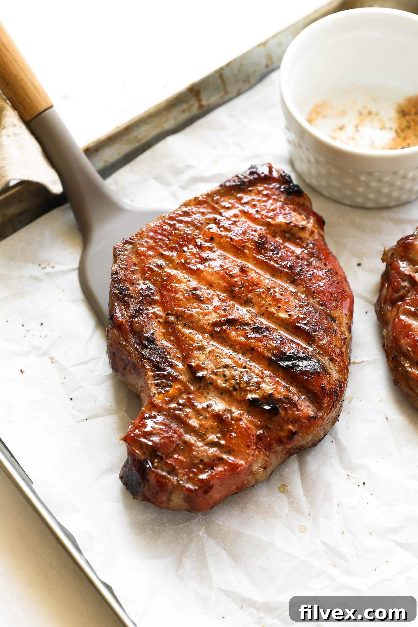 A stunning spread of Traeger smoked pork chops, garnished and ready to be served, highlighting their golden-brown crust.