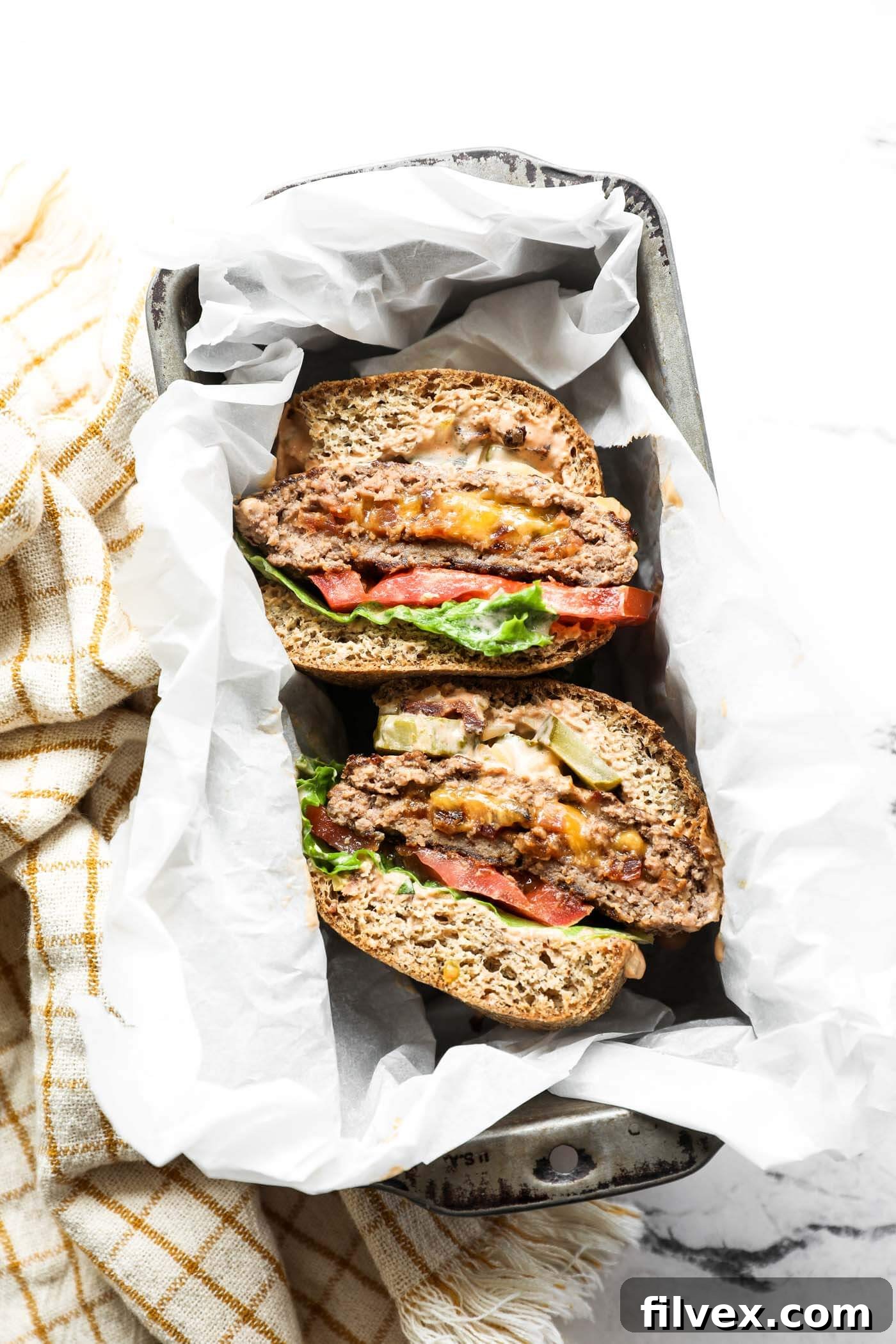 Overhead view of a perfectly plated cheese and bacon stuffed keto burger meal
