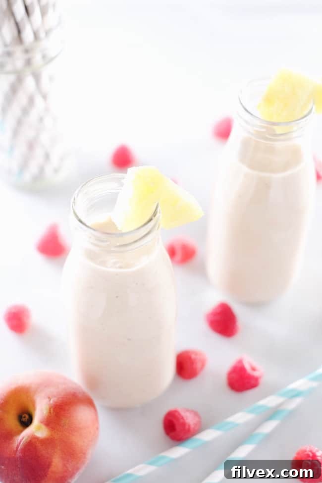 This peach berry pina colada smoothie is packed with peach, pineapple, raspberries and banana. It's clean, easy to make, and makes it feel like you're on vacation! Paleo and Refined Sugar-Free. | realsimplegood.com