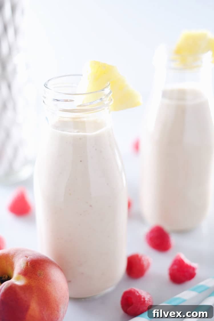 This peach berry pina colada smoothie is packed with peach, pineapple, raspberries and banana. It's clean, easy to make, and makes it feel like you're on vacation! Paleo and Refined Sugar-Free. | realsimplegood.com