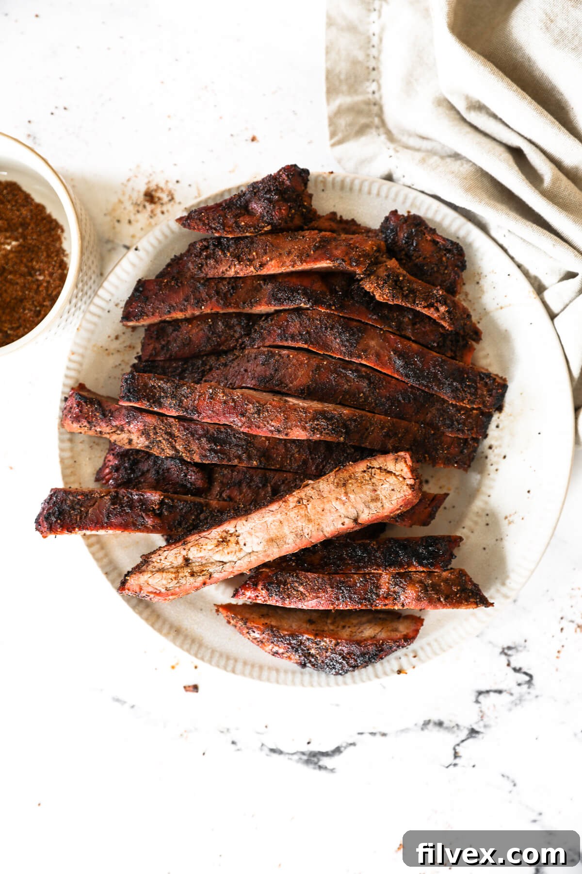 Close-up of the flavorful coffee rub crust on a grilled flank steak