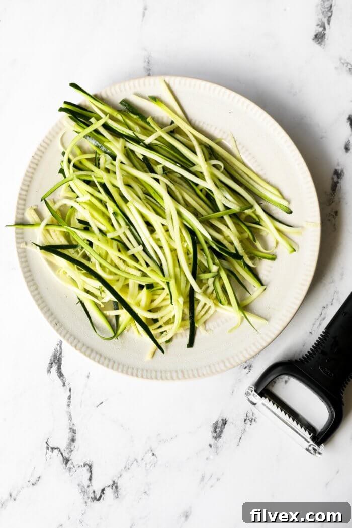 Image of zoodles on a plate, made from a veggie peeler.
