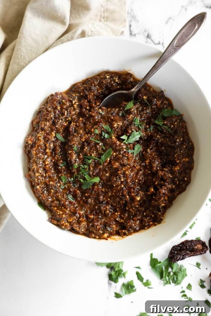 Vibrant red sun-dried tomato pesto in a bowl, ready to be served