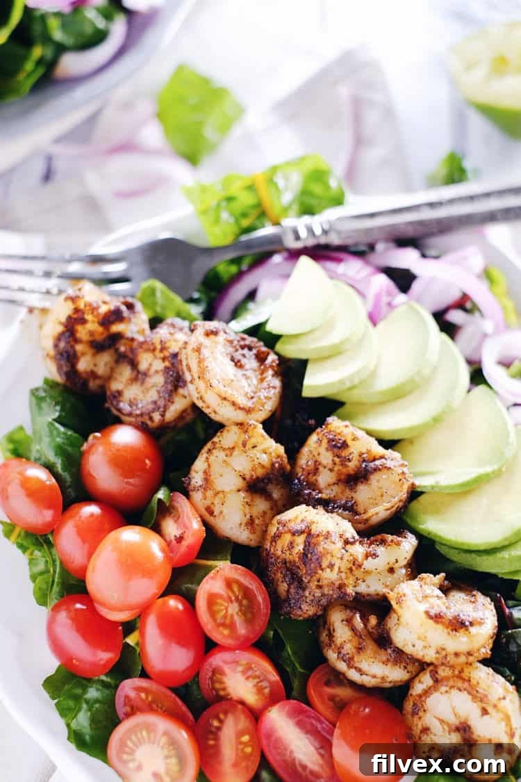 This cajun shrimp salad is an easy and fresh salad option. Make the Paleo + Whole30 salad packed with shrimp, avocado, tomato and onion! Paleo, Whole30, Gluten-Free + Dairy-Free. | realsimplegood.com