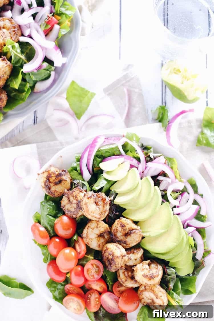 This cajun shrimp salad is an easy and fresh salad option. Make the Paleo + Whole30 salad packed with shrimp, avocado, tomato and onion! Paleo, Whole30, Gluten-Free + Dairy-Free. | realsimplegood.com