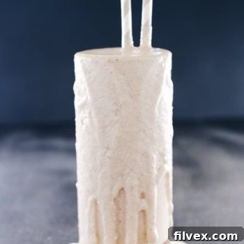 Straight on shot of banana almond butter smoothie in a glass