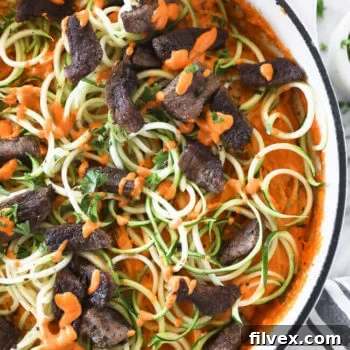 Roasted red pepper pasta with zucchini noodles in a pan