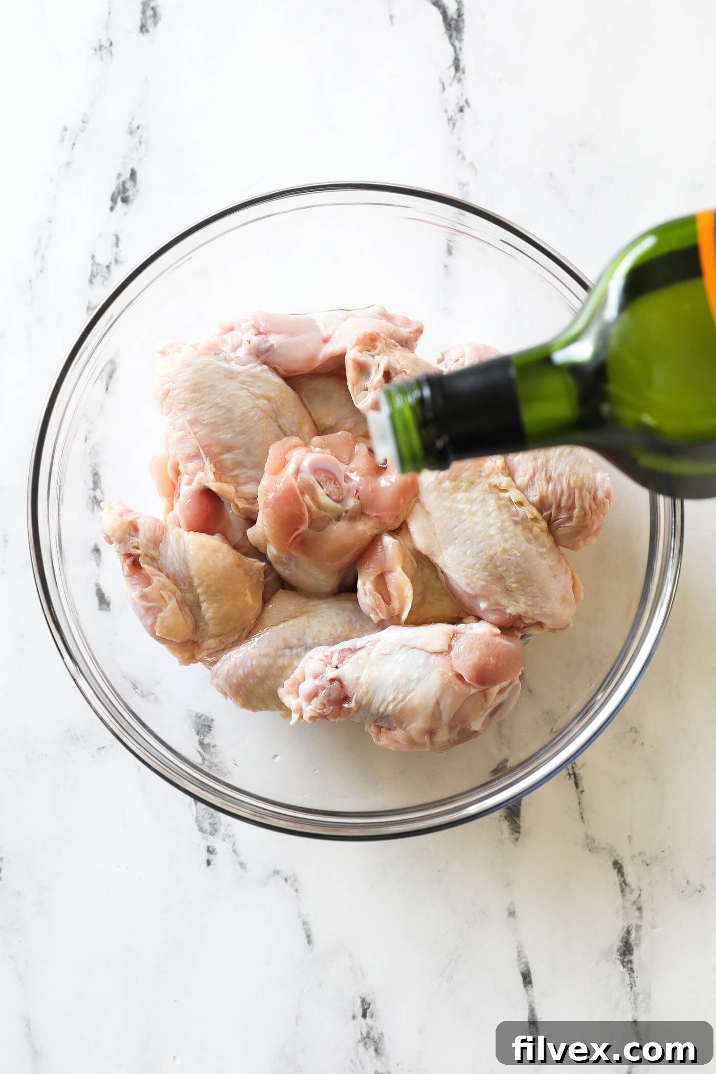 Place the wings in a bowl, drizzle with oil and toss to coat the wings completely with oil.