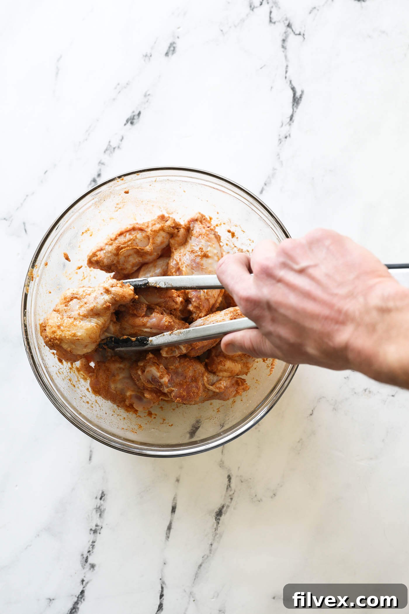 Toss the wings to coat them evenly with the seasoning.