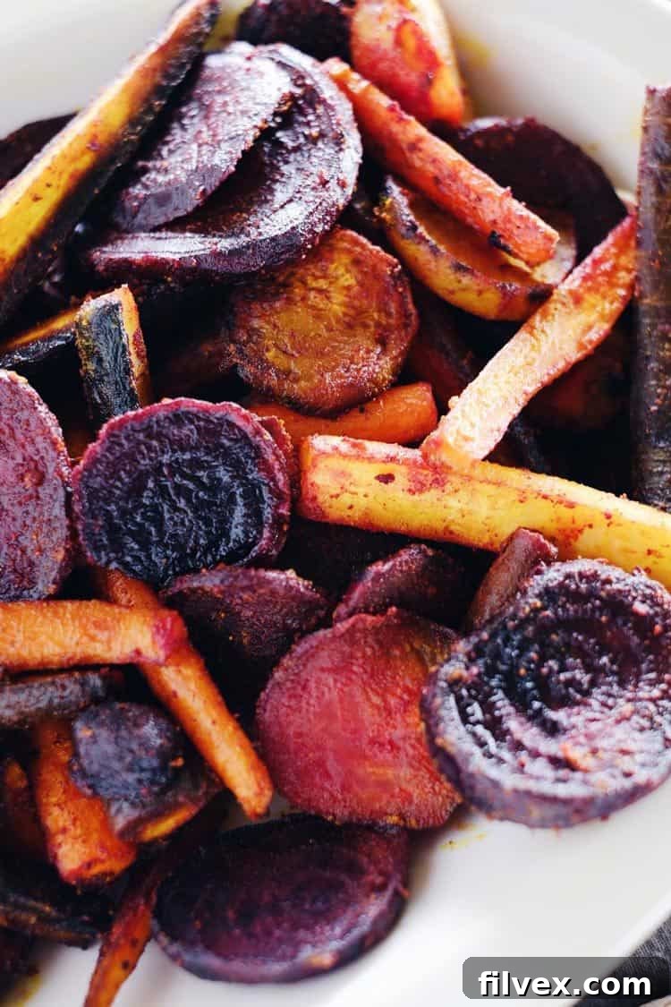 Turmeric Maple Roasted Beets and Carrots, beautifully caramelized and seasoned, ready to be served.
