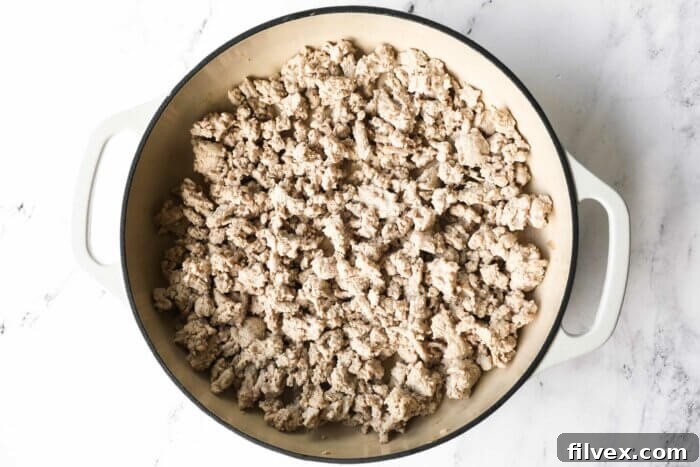 Cooked ground turkey crumbles in a pan