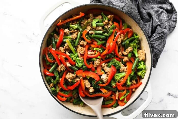 Overhead image of cooked ground turkey teriyaki stir fry in a pan