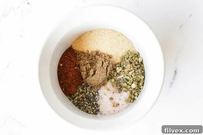 A small ramekin filled with the perfectly blended chicken seasoning mix, showcasing the spices.