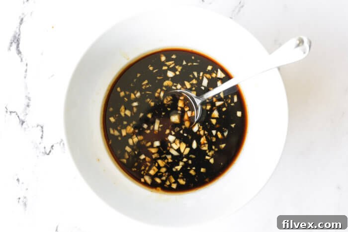Chicken stir fry sauce in a bowl with spoon