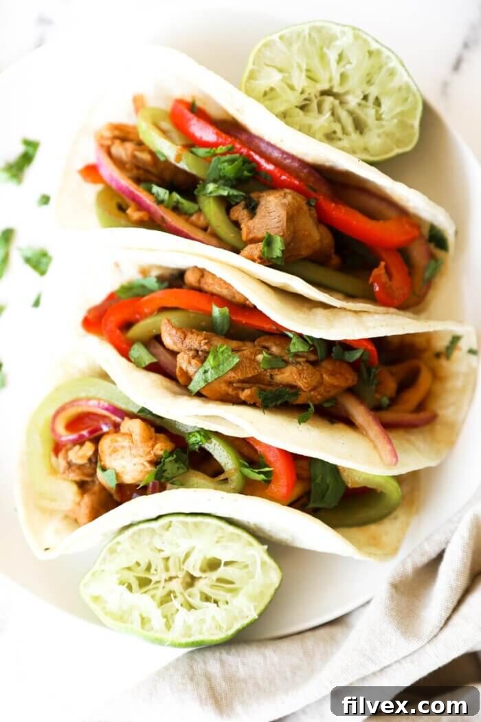 Chicken fajita mixture with vibrant bell peppers and onions in a skillet, ready to serve.