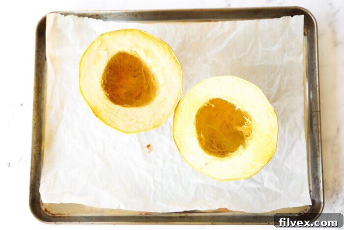 Roasted spaghetti squash on a baking sheet.