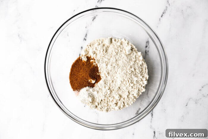 All the dry ingredients for making oat flour pancakes in a mixing bowl.
