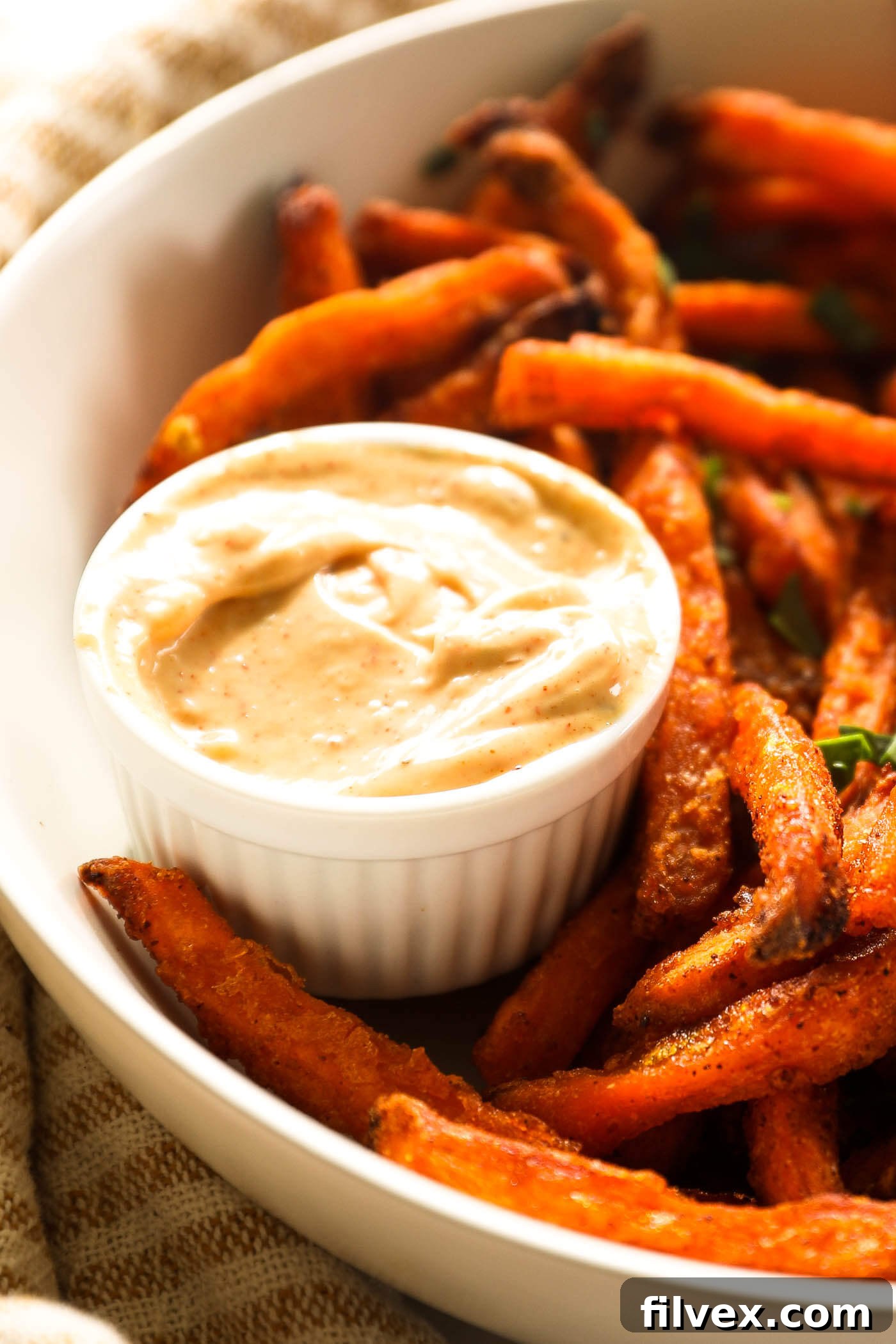 A close-up image of a bowl of creamy garlic dipping sauce, perfectly textured and ready for dipping.
