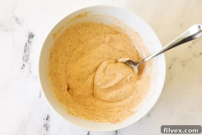 Mixed up sweet potato fries dipping sauce in a bowl, ready to be chilled and served.
