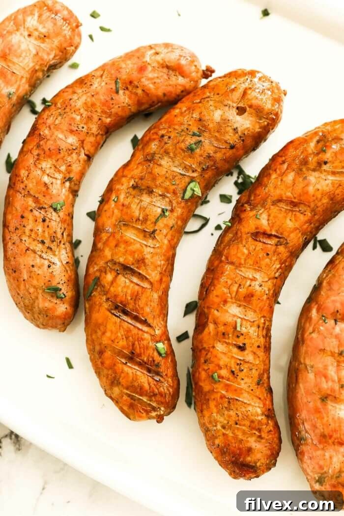 A selection of smoked sausages, sliced and presented on a rustic cutting board with a smoky aroma.