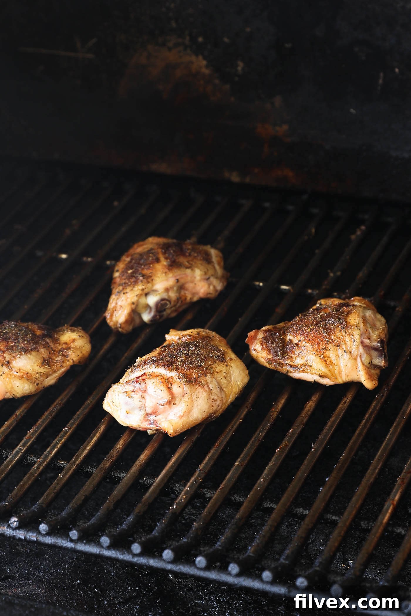 Reverse searing smoked chicken thighs at 450°F, flipping every 3-4 minutes