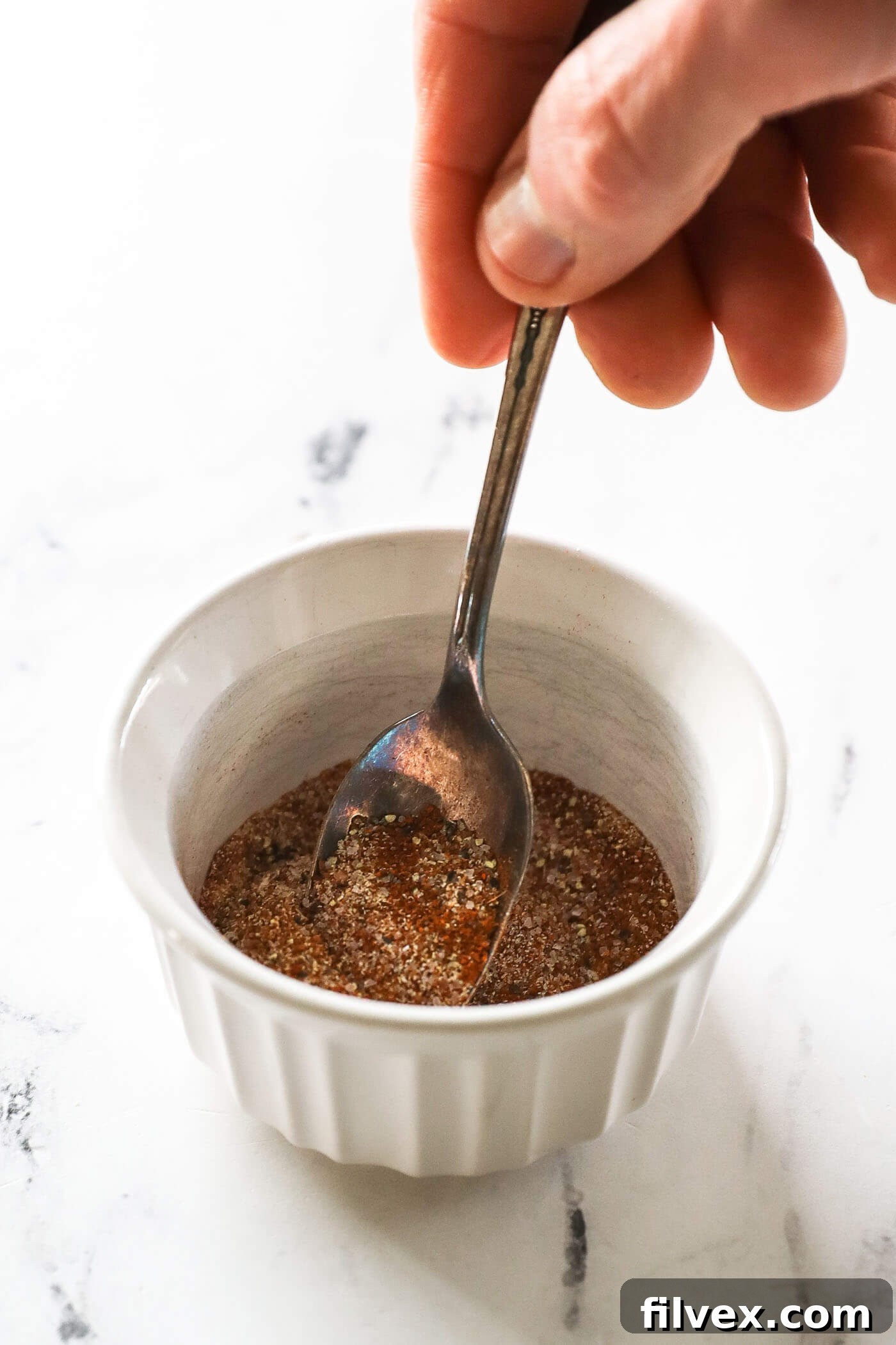 Smoker preheating to 225°F and a small bowl of tri-tip seasoning rub.
