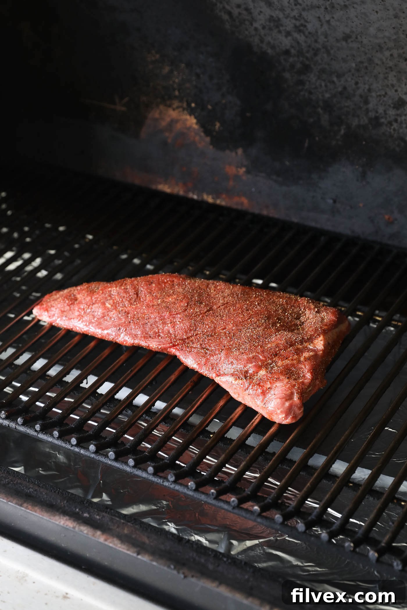 Tri-tip roast placed directly on the smoker grates.