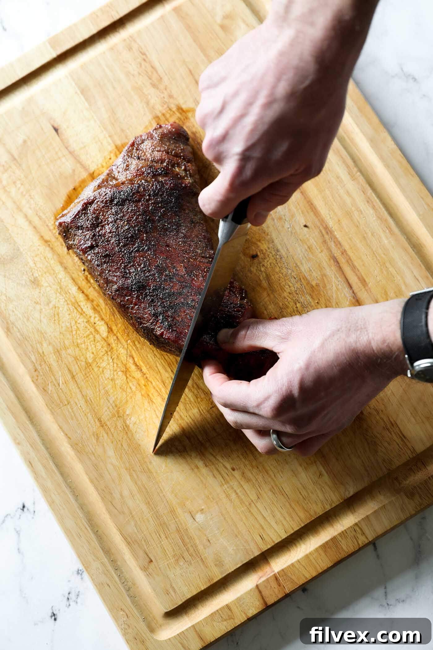 Resting tri-tip roast on a cutting board before slicing.