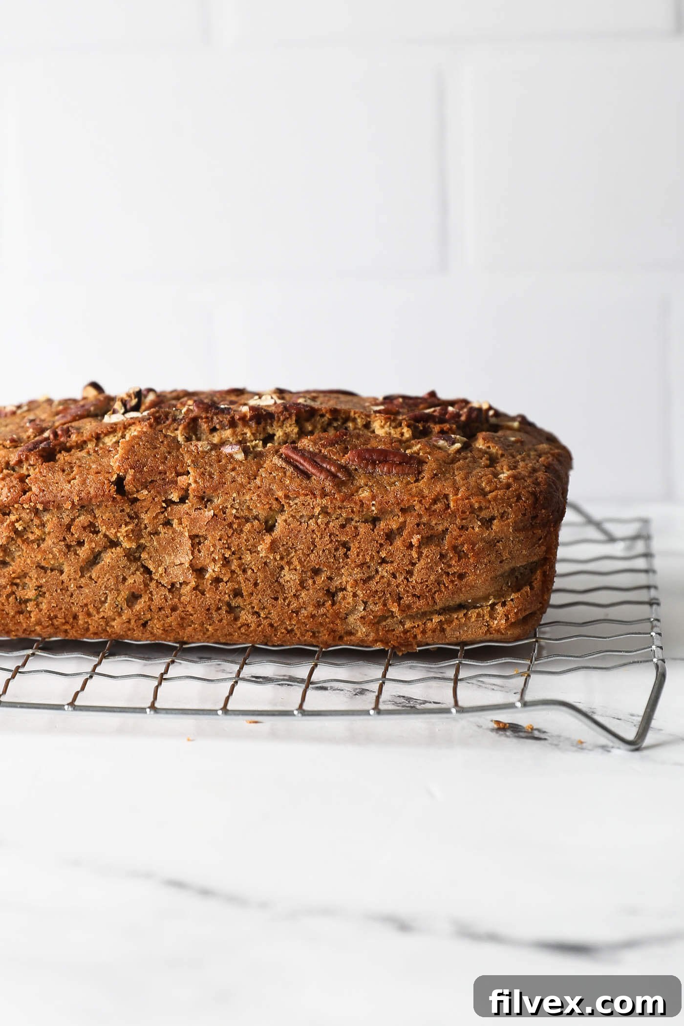 Straight on view of a loaf of zucchini bread on a cooling rack