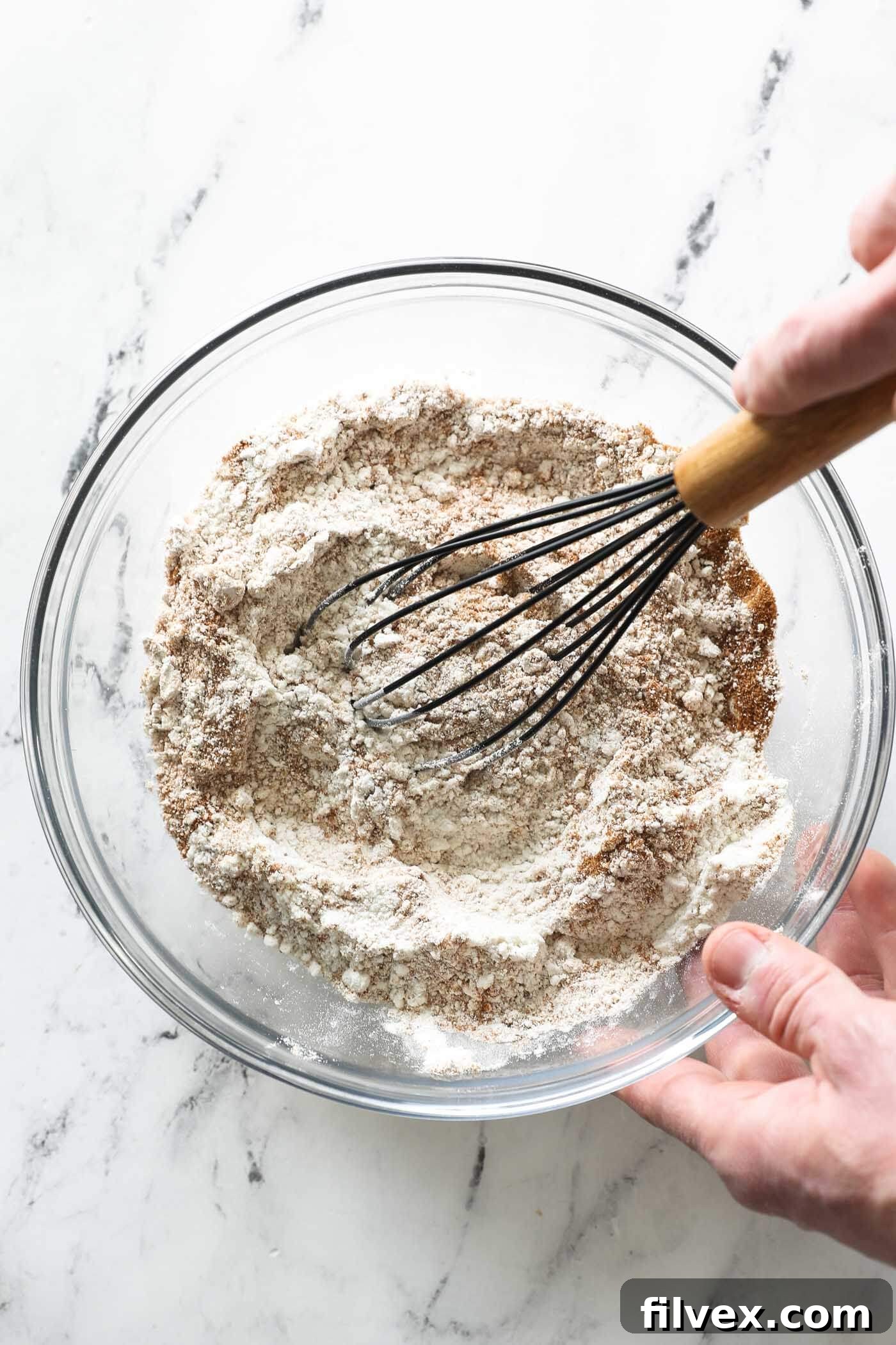 Whisking dry ingredients to make zucchini bread.