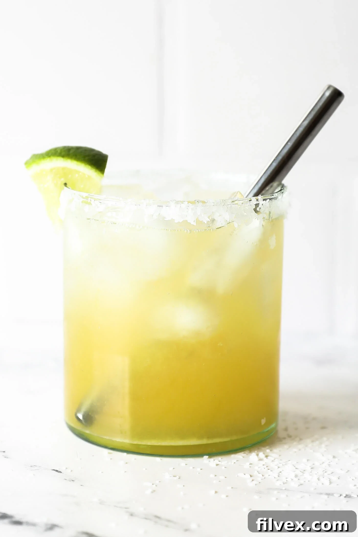 A beautifully garnished virgin margarita with a salted rim.