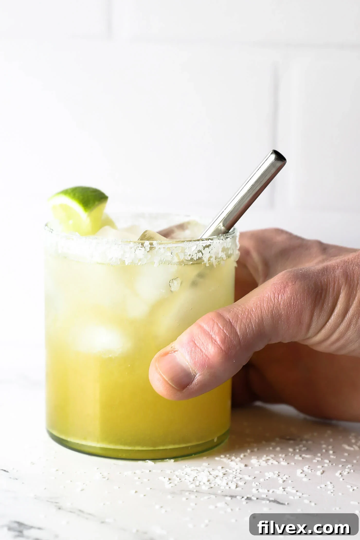 A freshly mixed virgin margarita being stirred gently.